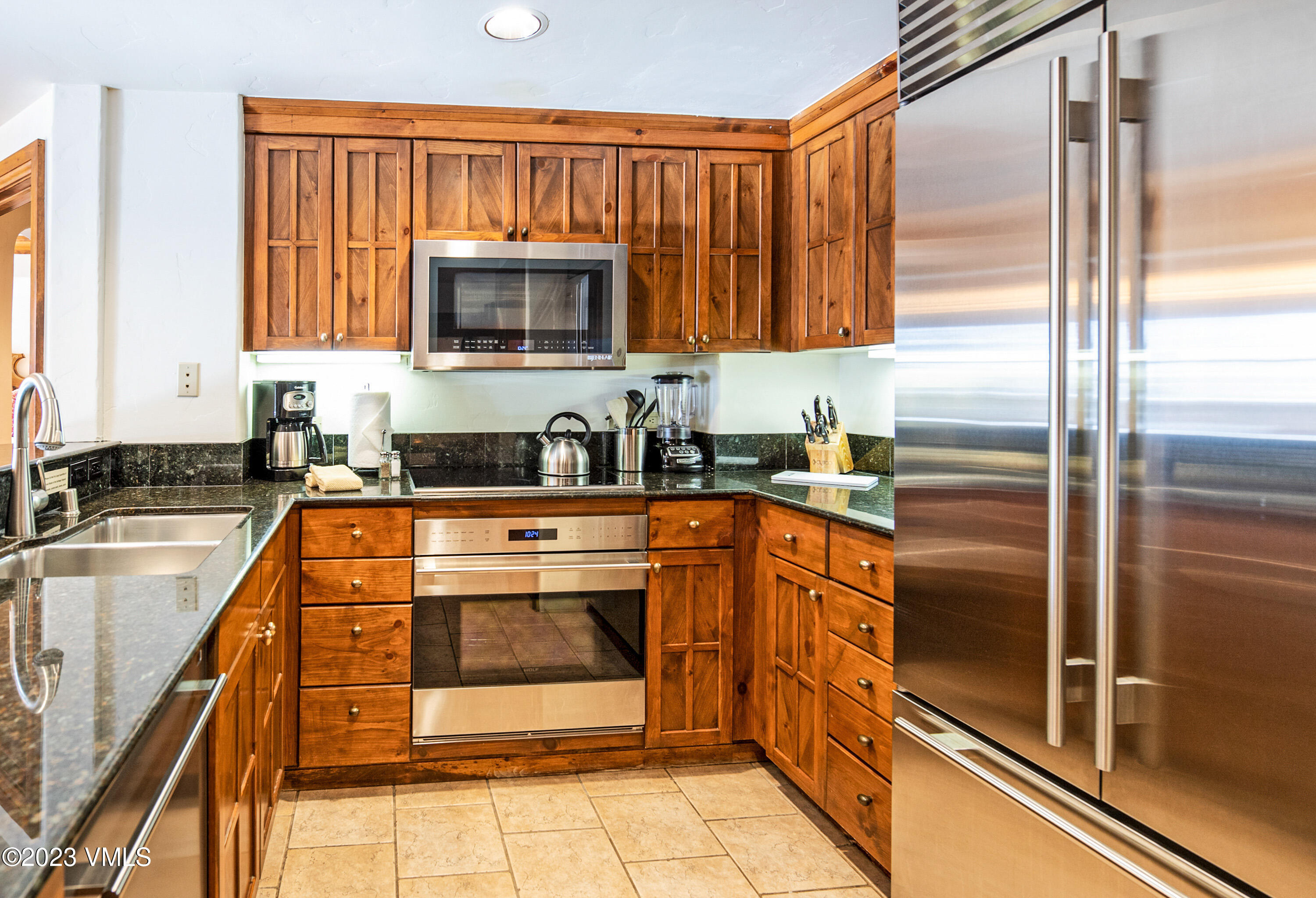 242 East Meadow Drive, Unit 1041 Vail, CO 81657 - Photo 19 of 46 a kitchen with a refrigerator and a sink
