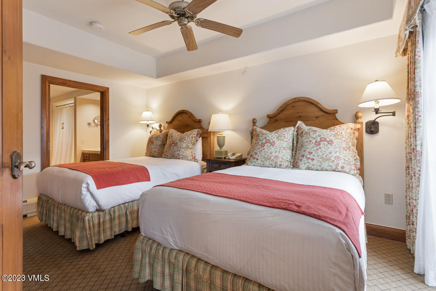 242 East Meadow Drive, Unit 1041 Vail, CO 81657 - Photo 37 of 46 a bedroom with bed and a chandelier