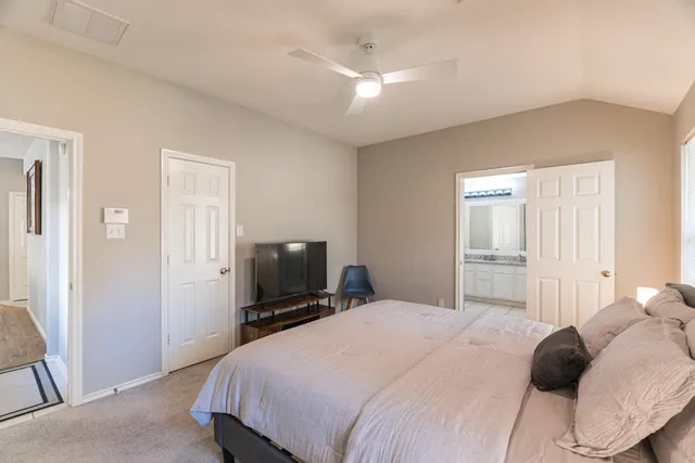 a bedroom with a bed and a flat screen tv
