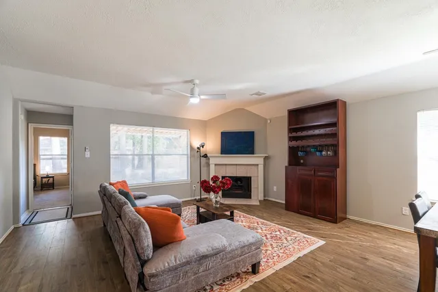 a bedroom with a large bed and a chandelier fan