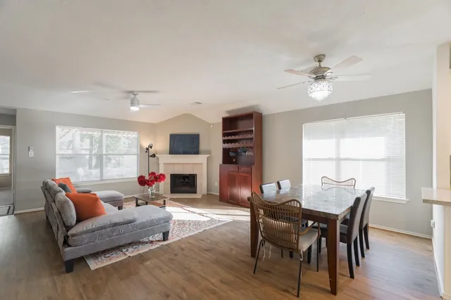 a bathroom with a granite countertop tub sink and mirror