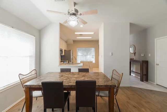 a view of a patio with table and chairs and a barbeque