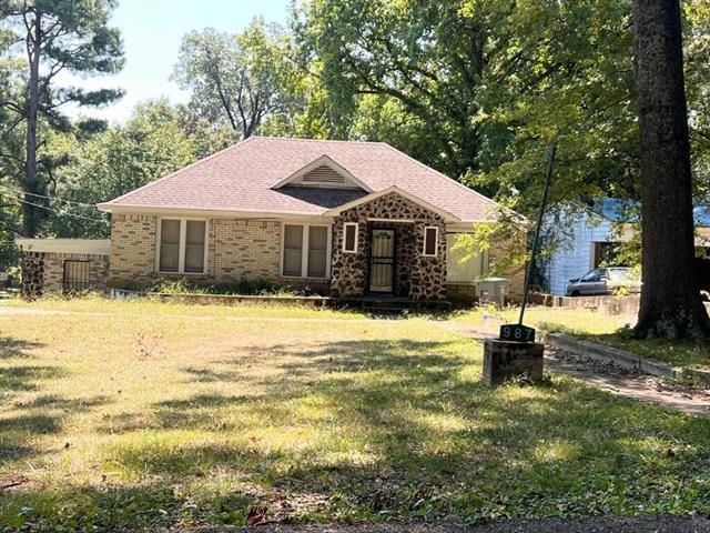 View of front facade featuring a front lawn and brick siding