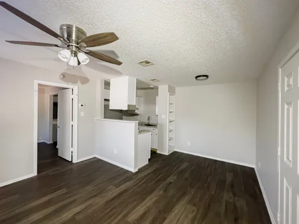 a view of a kitchen with a dishwasher cabinets and wooden floor