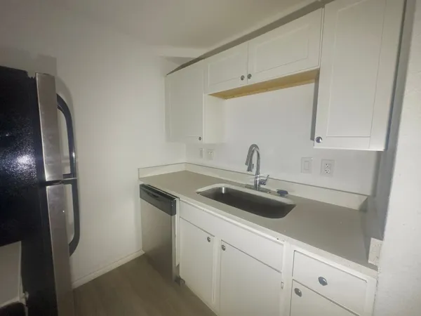 a view with a sink and refrigerator