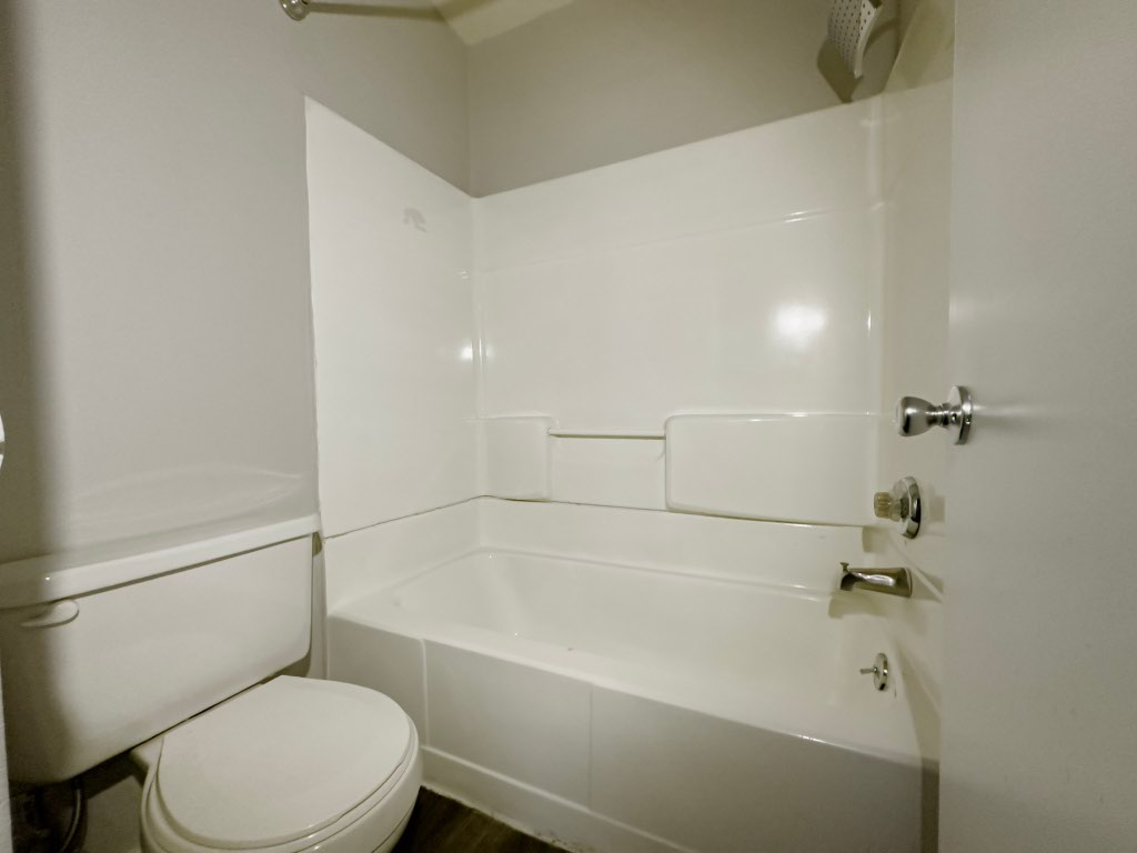 4500 Witham Lane, Unit 101 Austin, TX 78745 - Photo 25 of 27 Bathroom featuring washtub / shower combination and toilet