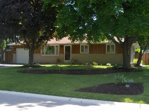 1507 Meadows Road Geneva, IL 60134 - Photo 1 of 1 a front view of a house with a garden