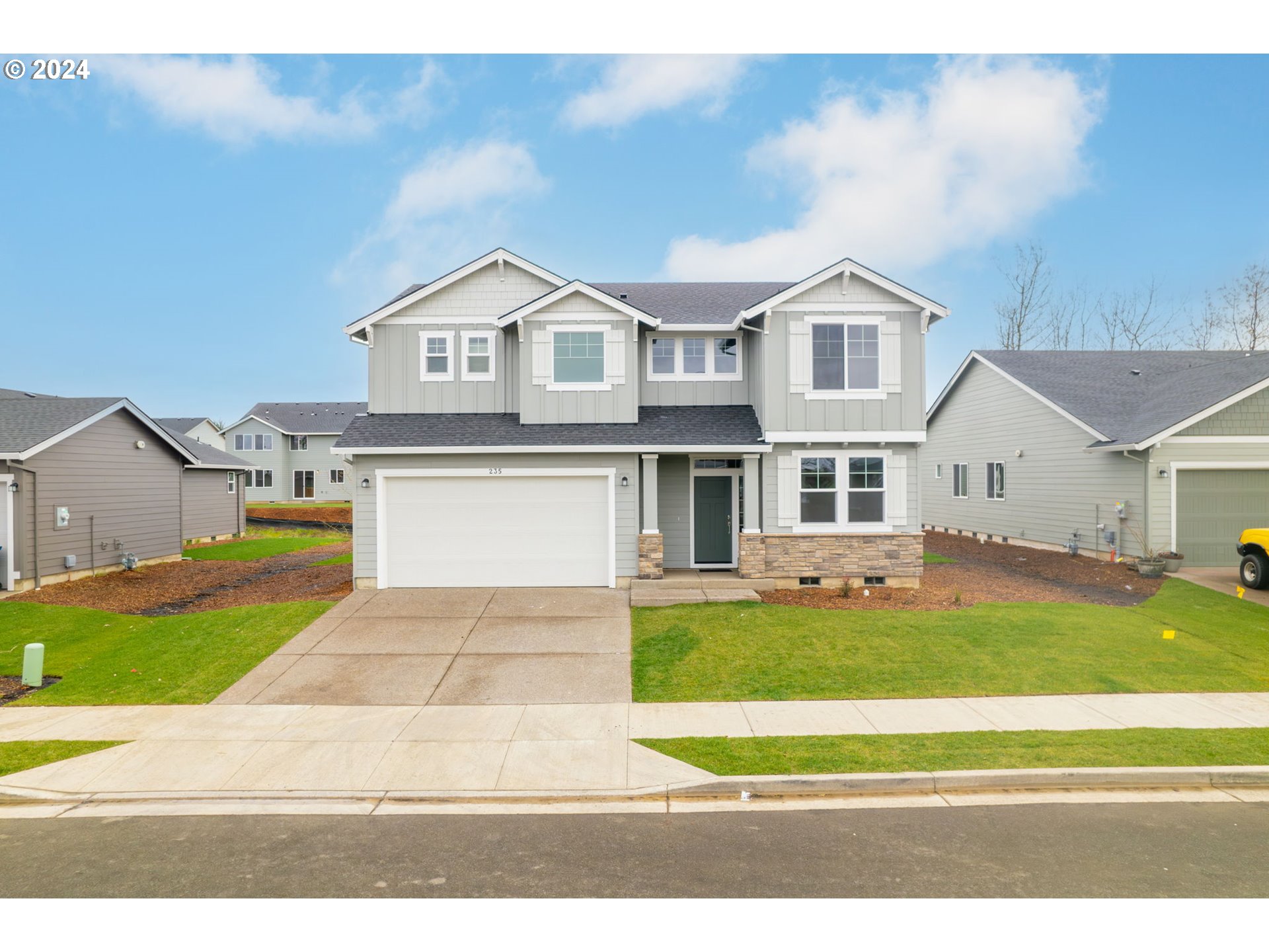 235 Walnut Street Mount Angel, OR 97362 - Photo 2 of 25 a view of a white house with a big yard and large trees