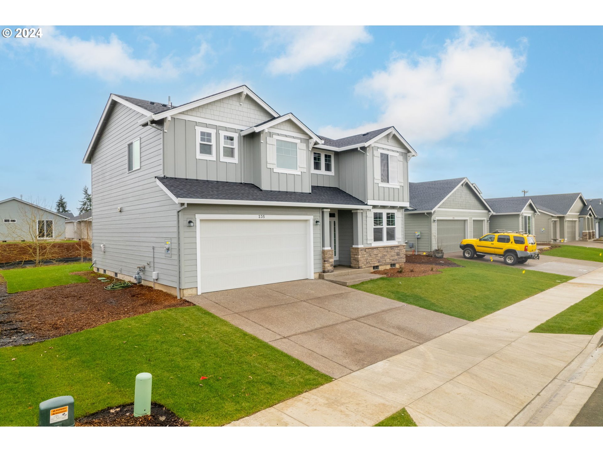 235 Walnut Street Mount Angel, OR 97362 - Photo 3 of 25 a front view of a house with a yard and garage