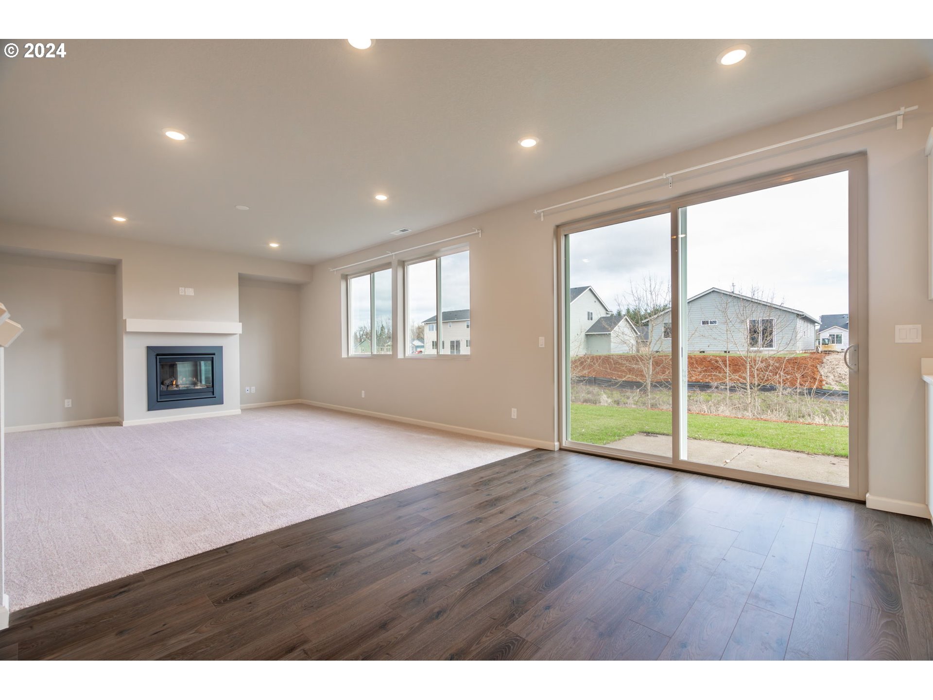 235 Walnut Street Mount Angel, OR 97362 - Photo 7 of 25 a view of empty room with wooden floor and fireplace