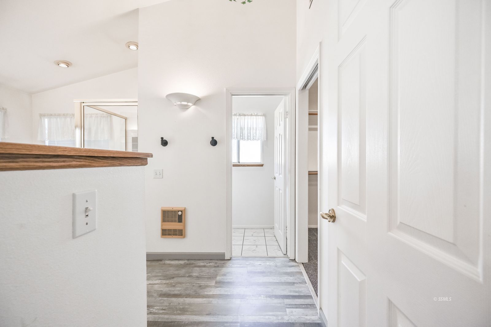 1209 West Robert Avenue Ridgecrest, CA 93555 - Photo 37 of 50 a view of a hallway with wooden floor and staircase