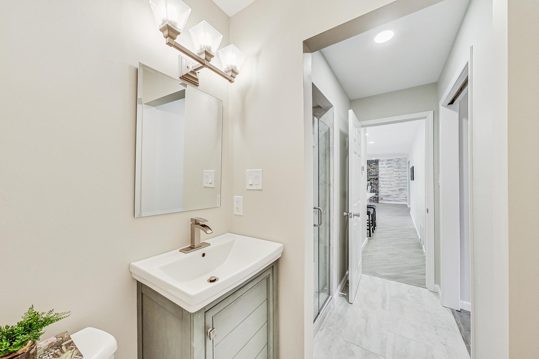22 Chrismar Road Ogden Dunes, IN 46368 - Photo 11 of 26 a bathroom with a sink a toilet and shower