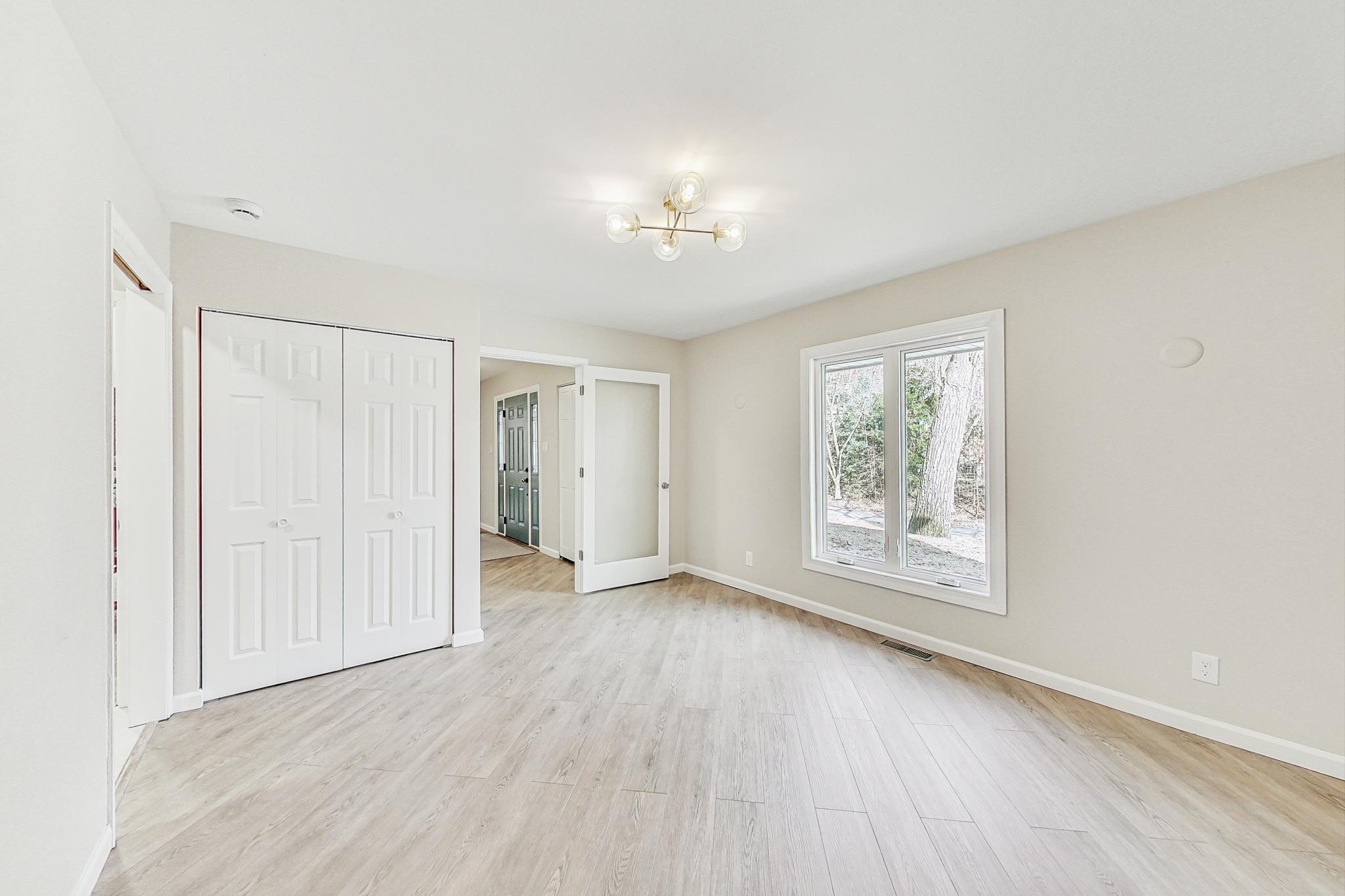 22 Chrismar Road Ogden Dunes, IN 46368 - Photo 12 of 26 an empty room with wooden floor and windows