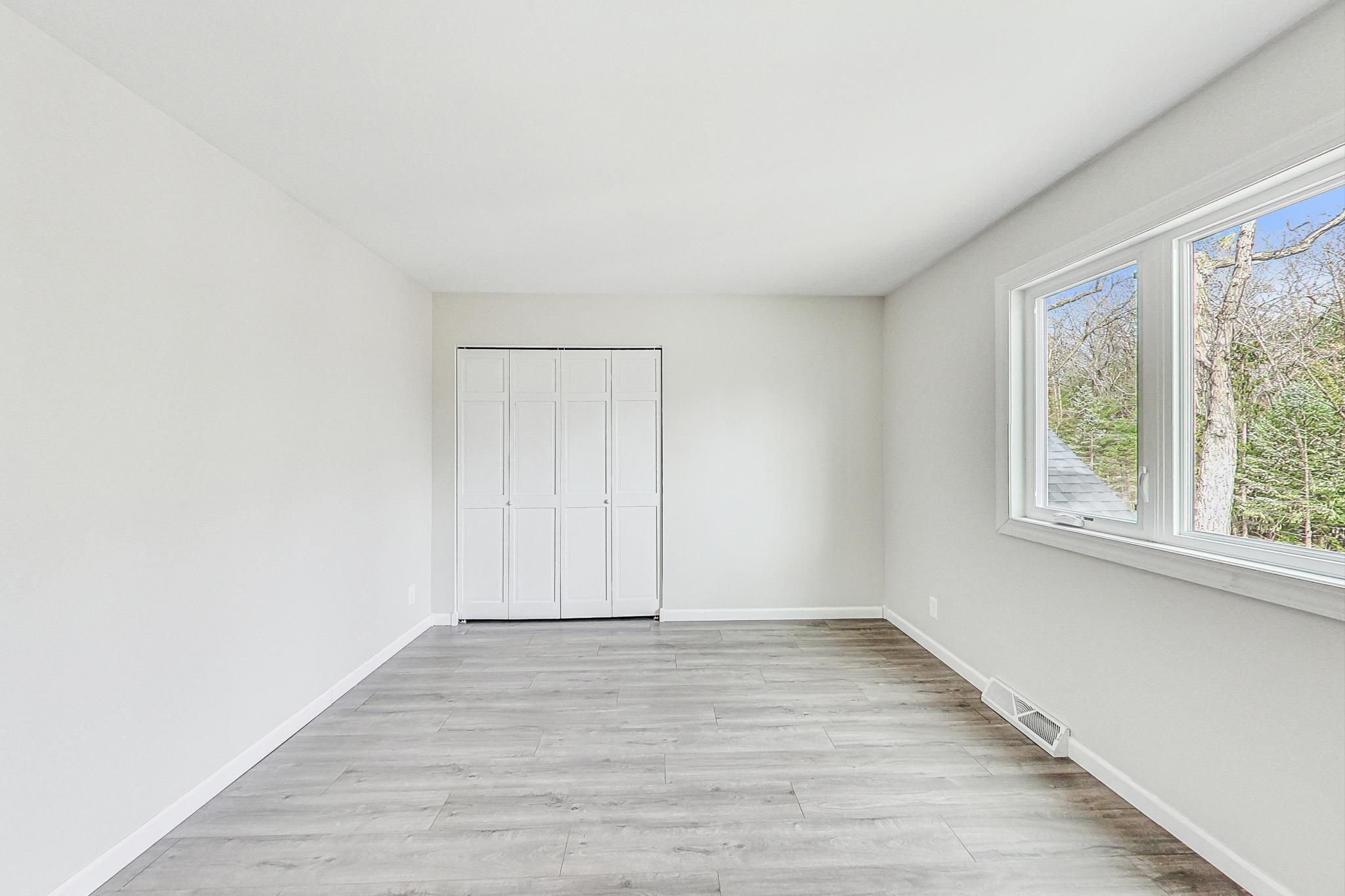 22 Chrismar Road Ogden Dunes, IN 46368 - Photo 14 of 26 an empty room with wooden floor and windows