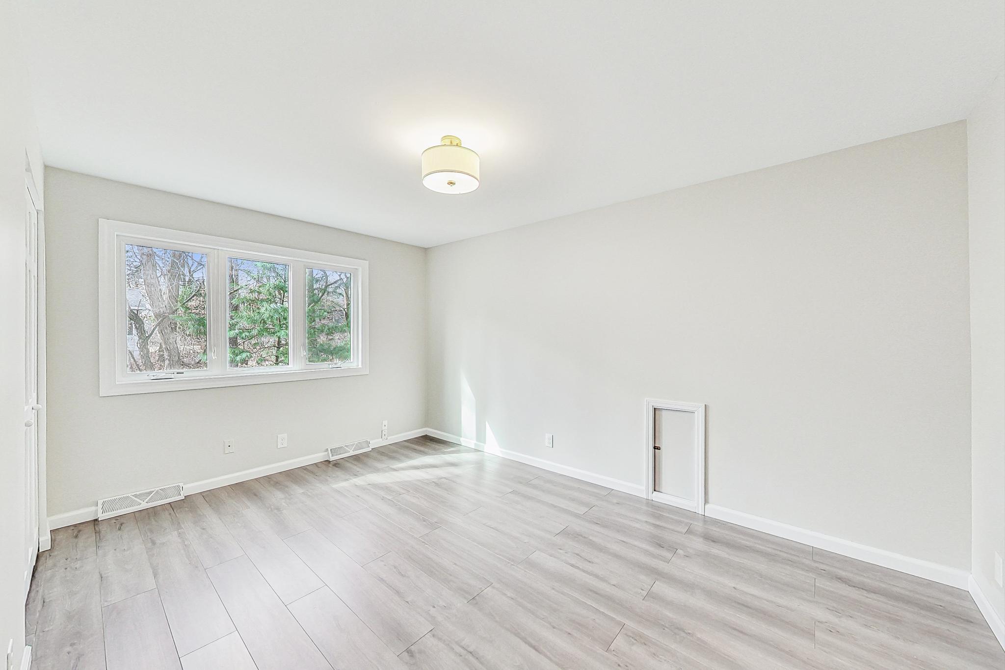 22 Chrismar Road Ogden Dunes, IN 46368 - Photo 17 of 26 an empty room with wooden floor and windows