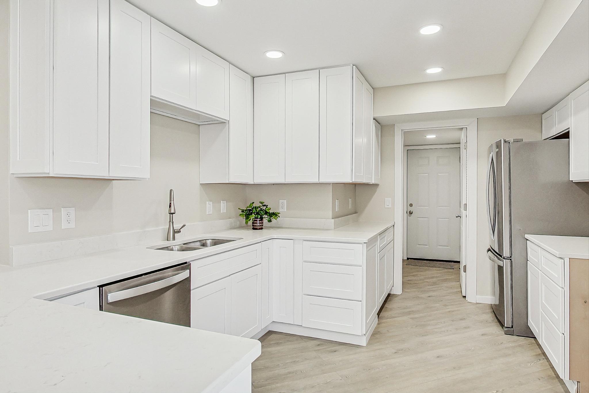 22 Chrismar Road Ogden Dunes, IN 46368 - Photo 8 of 26 a kitchen with white cabinets and white appliances