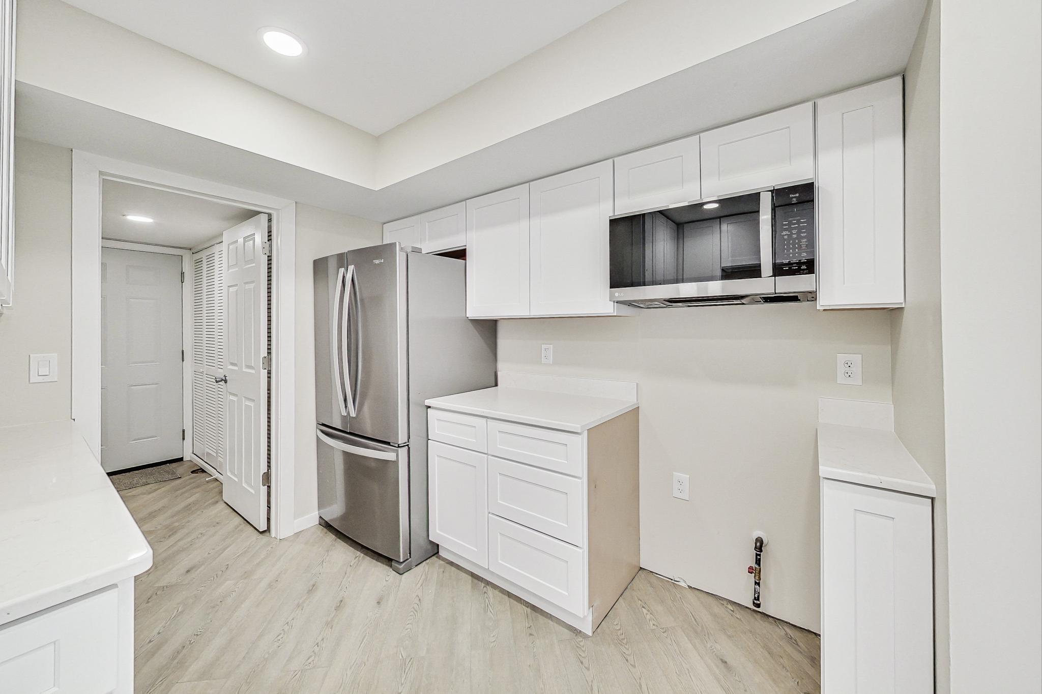22 Chrismar Road Ogden Dunes, IN 46368 - Photo 9 of 26 a kitchen with a refrigerator stove and cabinets