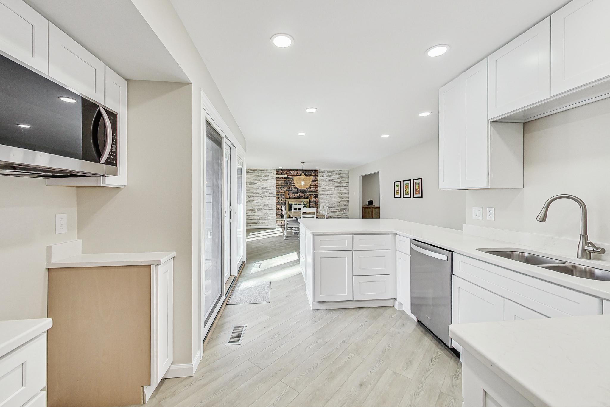 22 Chrismar Road Ogden Dunes, IN 46368 - Photo 10 of 26 a kitchen with white cabinets and sink