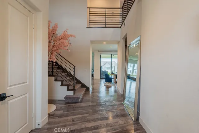 a view of entryway and hall with wooden floor