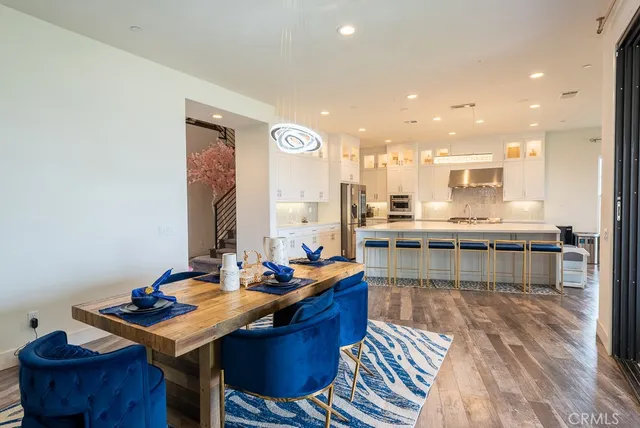 a room with a table chairs and flat screen tv