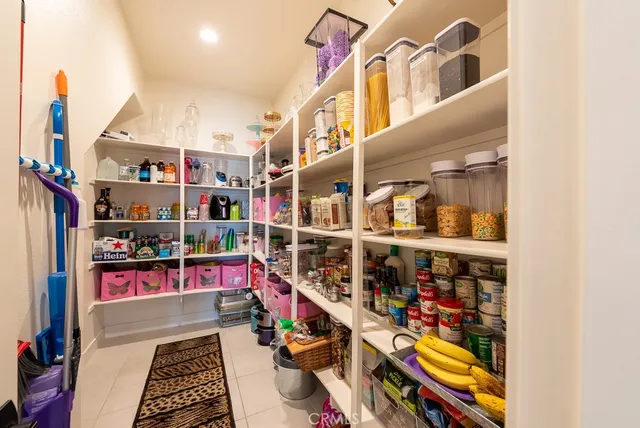 a bedroom with a bed and flat tv screen on the dresser