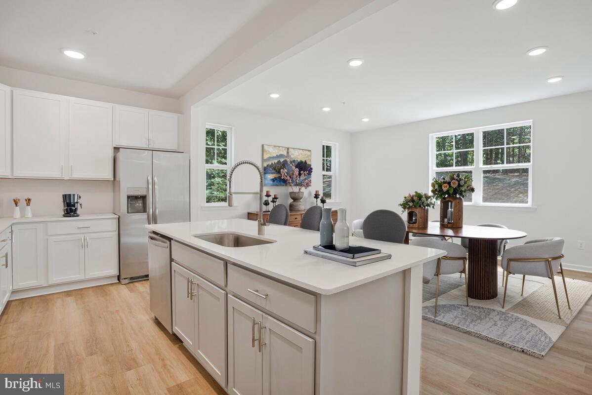 721 Nollmeyer Road Middle River, MD 21220 - Photo 7 of 28 a kitchen that has a sink a table and chairs in it