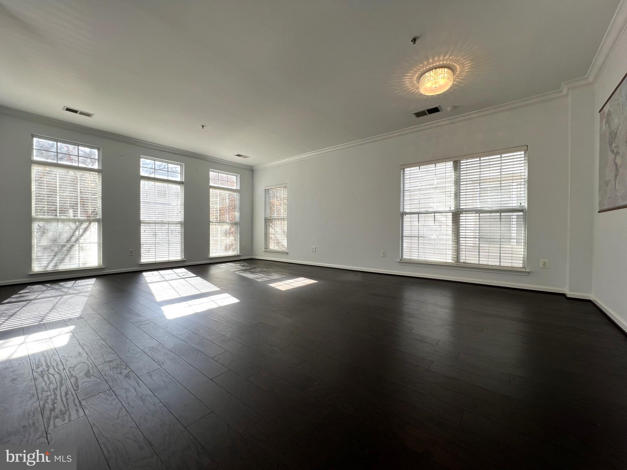 640 Main Street, Unit 640B Gaithersburg, MD 20878 - Photo 11 of 65 an empty room with wooden floor and windows