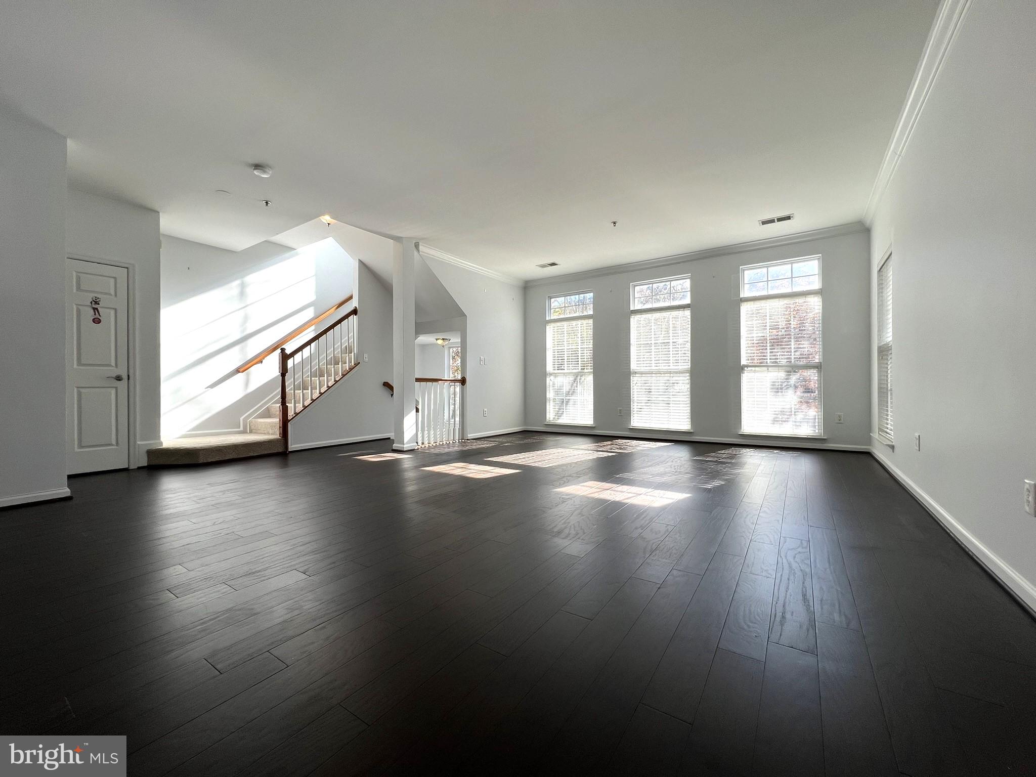 640 Main Street, Unit 640B Gaithersburg, MD 20878 - Photo 12 of 65 a view of an empty room with wooden floor and a window