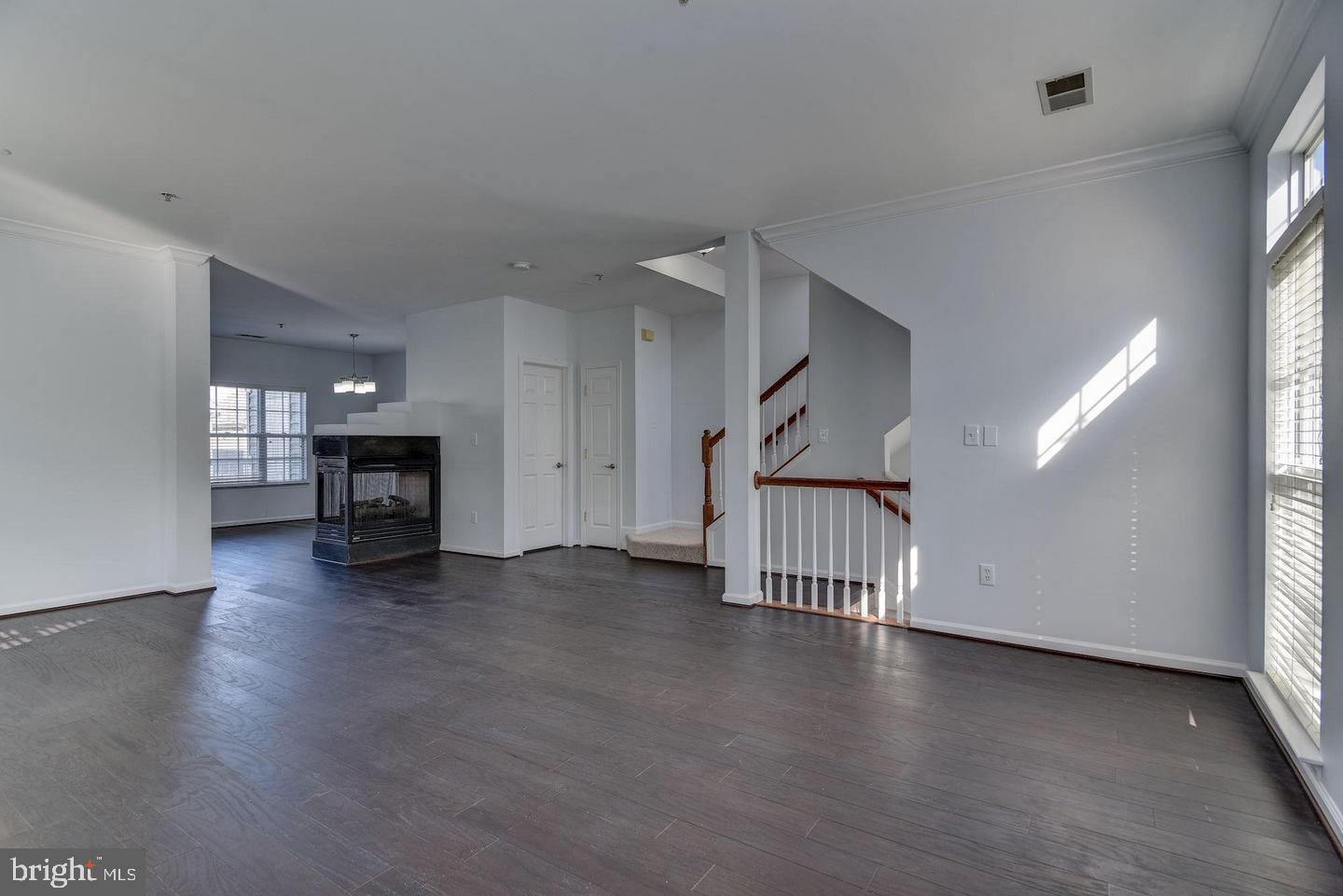 640 Main Street, Unit 640B Gaithersburg, MD 20878 - Photo 13 of 65 an empty room with fireplace wooden floor and windows