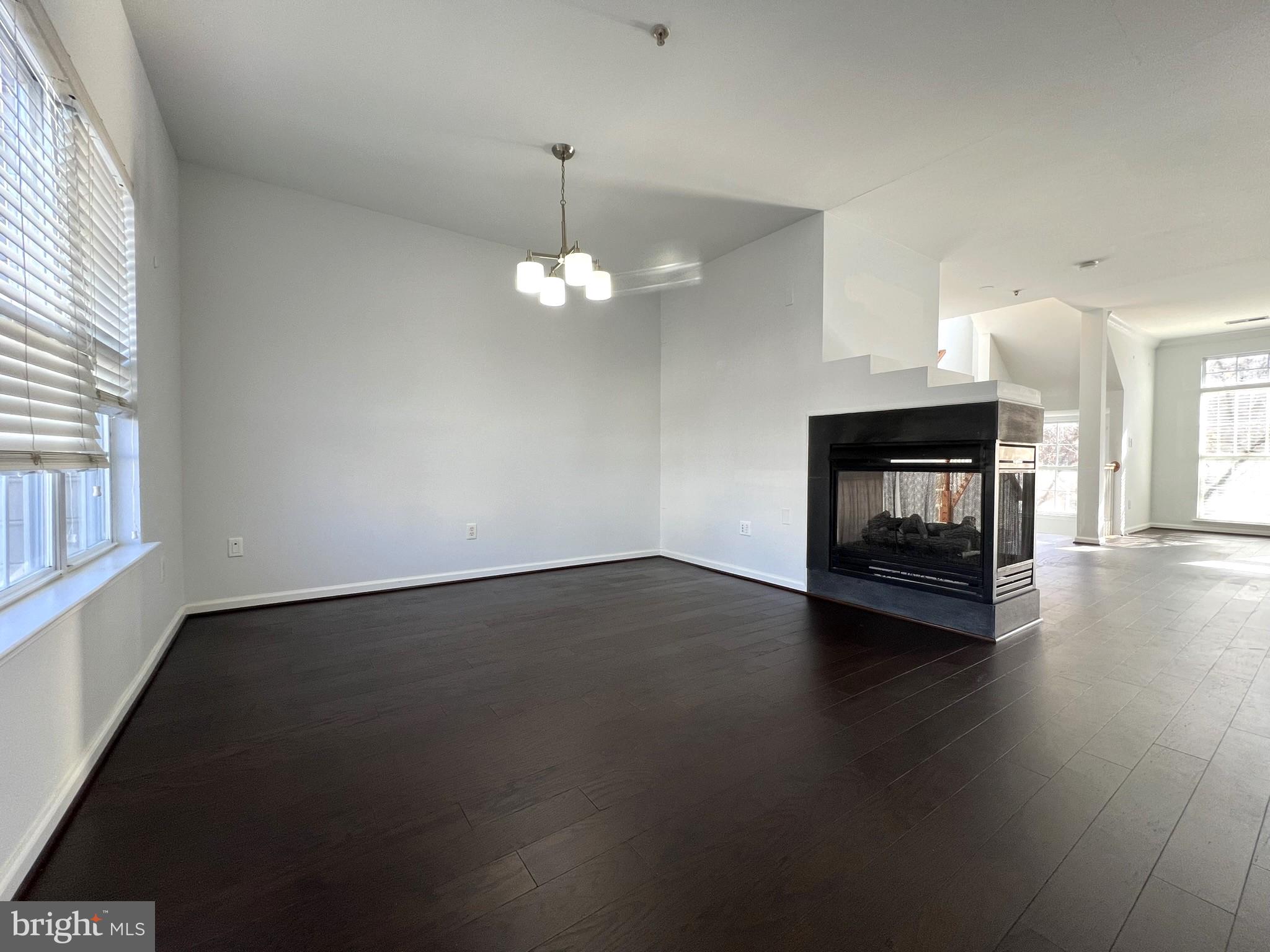 640 Main Street, Unit 640B Gaithersburg, MD 20878 - Photo 16 of 65 a view of an empty room with wooden floor and a window