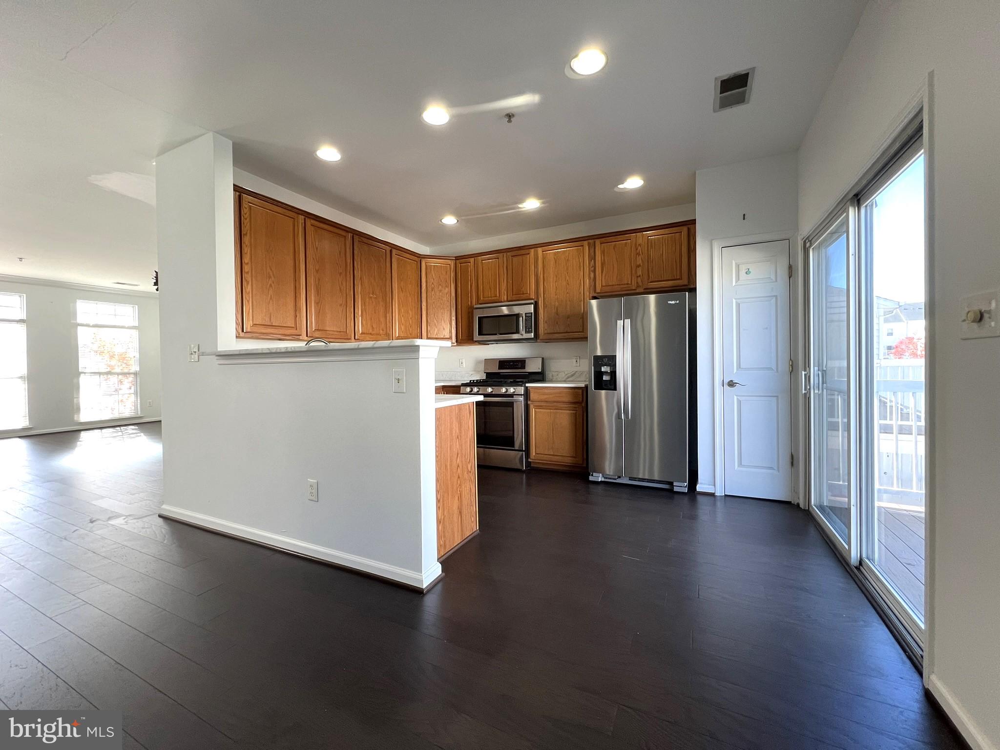 640 Main Street, Unit 640B Gaithersburg, MD 20878 - Photo 19 of 65 a view of kitchen with stainless steel appliances wooden floor and a window