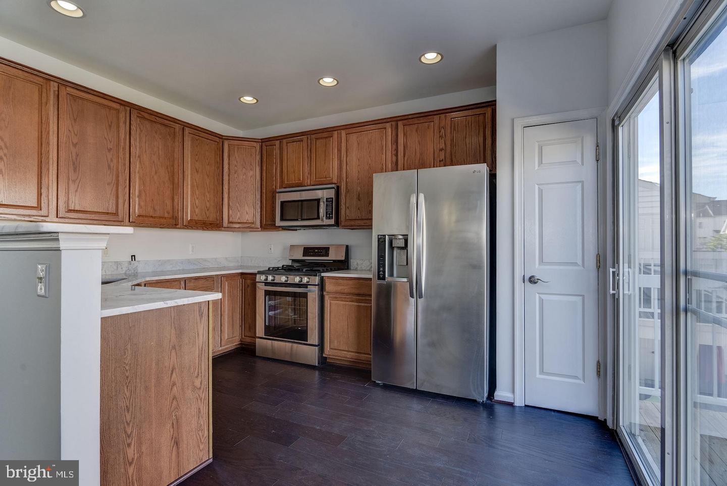 640 Main Street, Unit 640B Gaithersburg, MD 20878 - Photo 21 of 65 a kitchen with a refrigerator sink and stove top oven