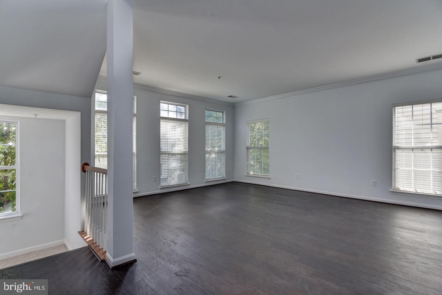 640 Main Street, Unit 640B Gaithersburg, MD 20878 - Photo 5 of 65 a view of an empty room with wooden floor and a window