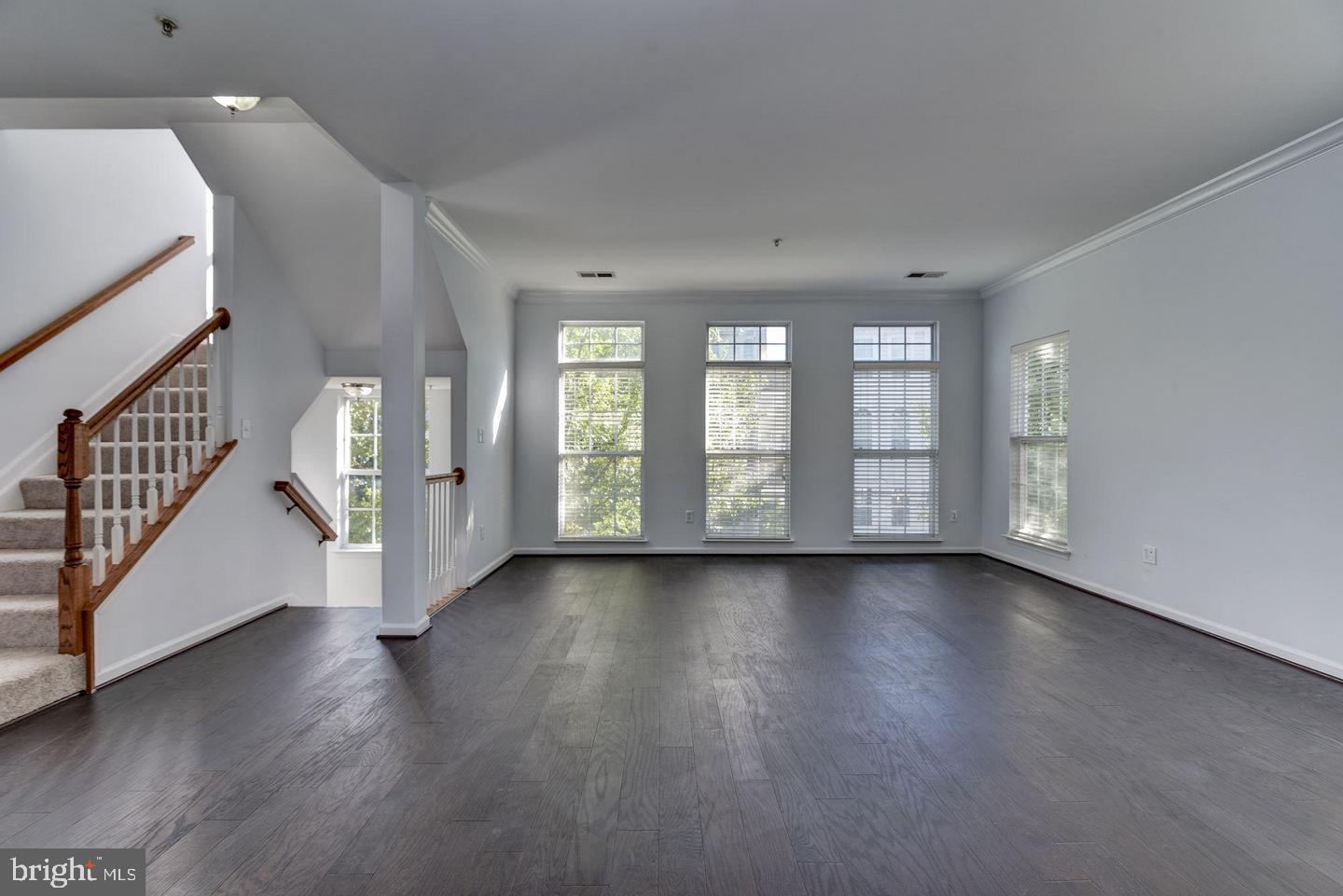 640 Main Street, Unit 640B Gaithersburg, MD 20878 - Photo 6 of 65 an empty room with wooden floor and windows