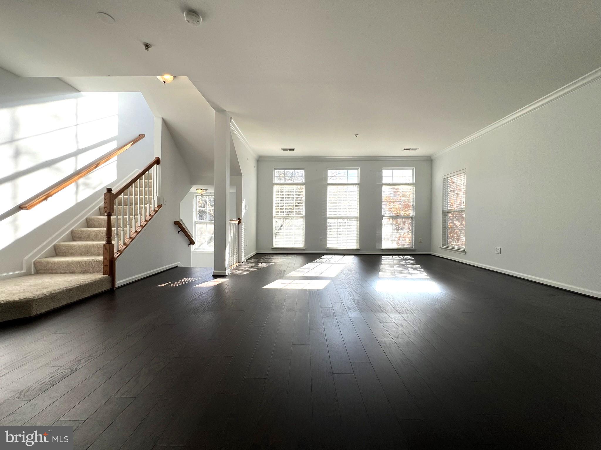 640 Main Street, Unit 640B Gaithersburg, MD 20878 - Photo 7 of 65 a view of an empty room with wooden floor and a window