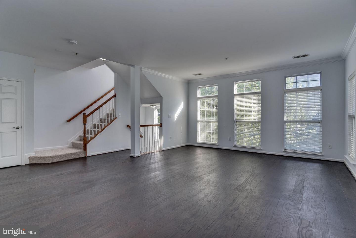 640 Main Street, Unit 640B Gaithersburg, MD 20878 - Photo 8 of 65 an empty room with wooden floor and windows
