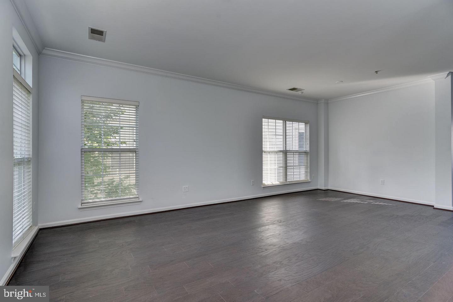 640 Main Street, Unit 640B Gaithersburg, MD 20878 - Photo 9 of 65 an empty room with wooden floor and windows