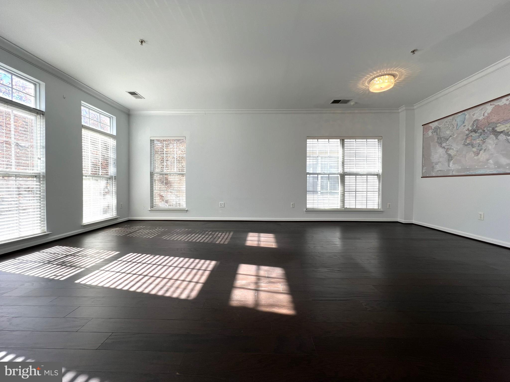 640 Main Street, Unit 640B Gaithersburg, MD 20878 - Photo 10 of 65 a view of an empty room with wooden floor and a window
