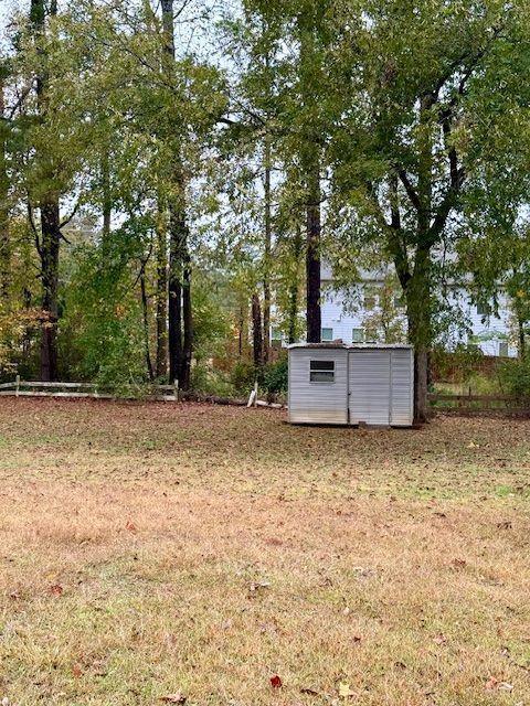 1840 Flat Shoals Road Southeast Conyers, GA 30013 - Photo 10 of 10 a backyard of a house with trees