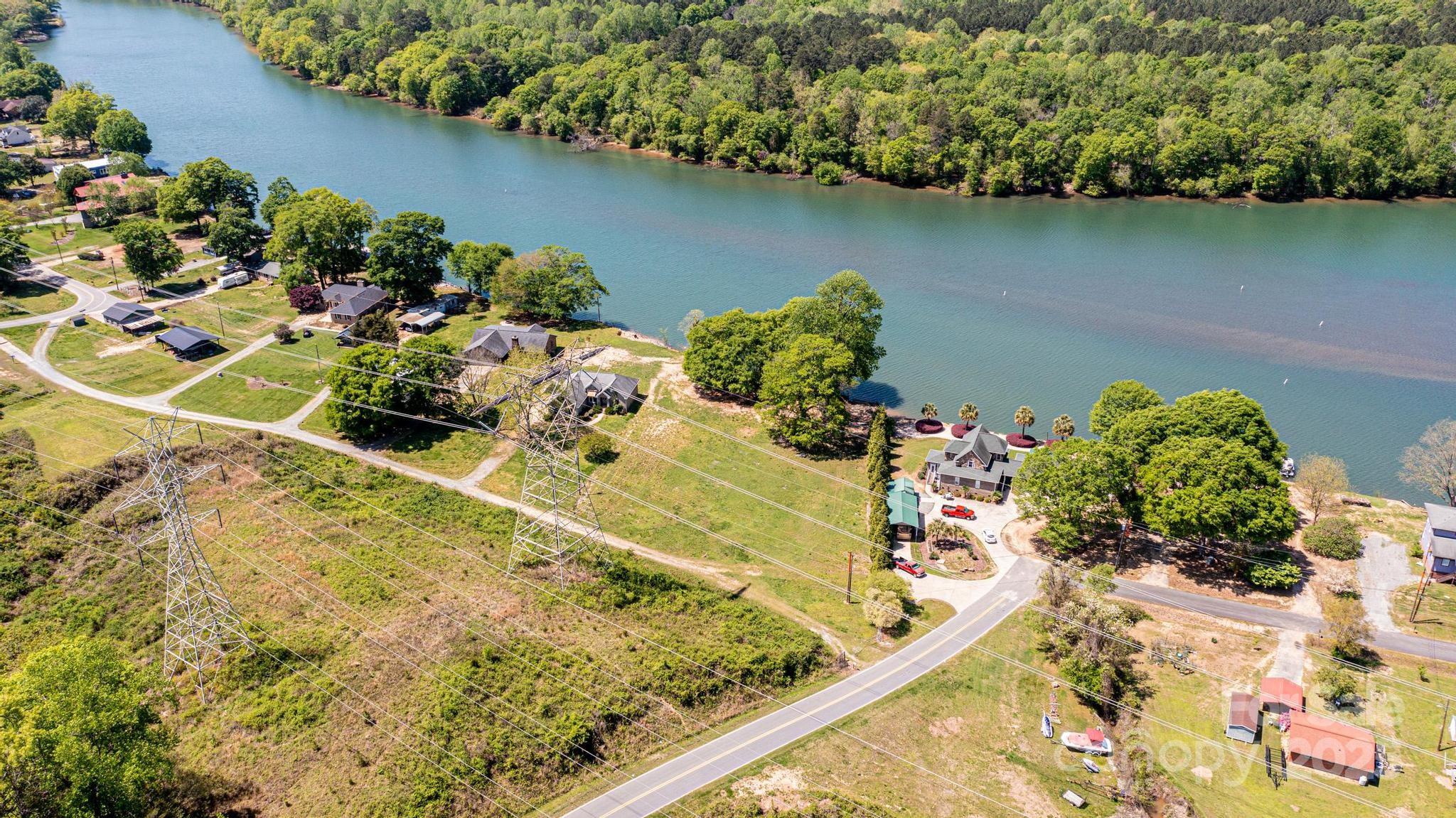 1404 Hart Road Charlotte, NC 28214 - Photo 7 of 9 a view of a lake with a table and chairs in patio