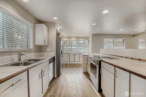 a kitchen with a sink stove and cabinets