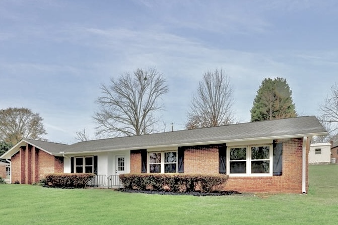 1007 Brown Road Anderson, SC 29621 - Photo 1 of 1 This ranch-style home features classic brick and white siding, surrounded by a verdant lawn.