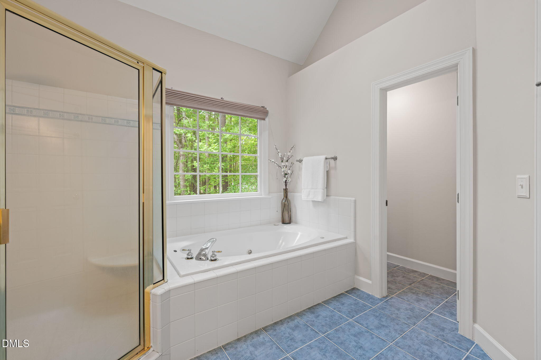 5809 Stone Spring Road Raleigh, NC 27613 - Photo 25 of 54 a bathroom with a bathtub and a shower