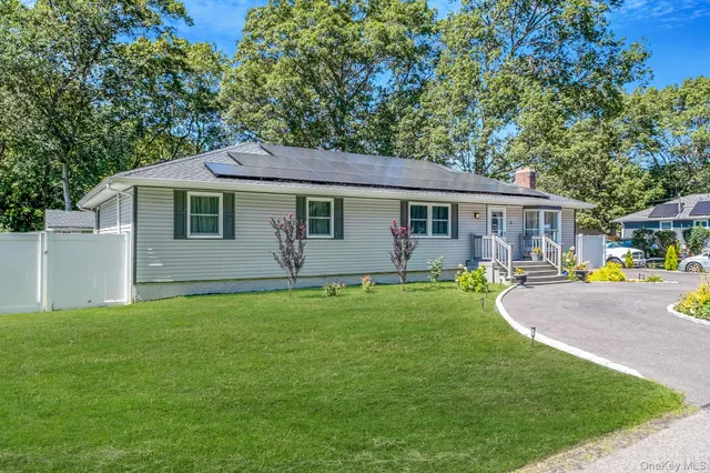 a view of a house with a yard and sitting area