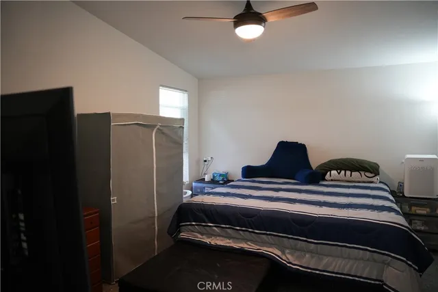 a bedroom with bed and wooden floor