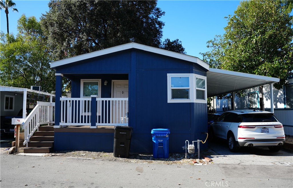 6545 Wilbur, Unit 39 Reseda, CA 91335 - Photo 2 of 27 a front view of a house with a yard