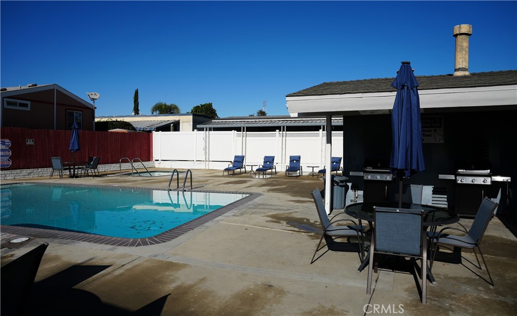 6545 Wilbur, Unit 39 Reseda, CA 91335 - Photo 27 of 27 a view of a patio with table and chairs with wooden floor and fence