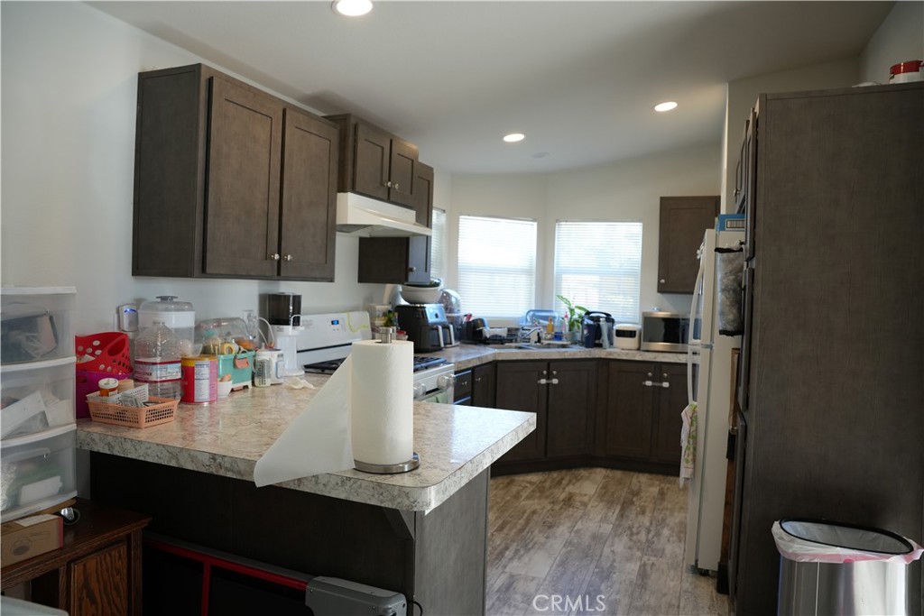 6545 Wilbur, Unit 39 Reseda, CA 91335 - Photo 5 of 27 a kitchen with granite countertop a sink stove and cabinets