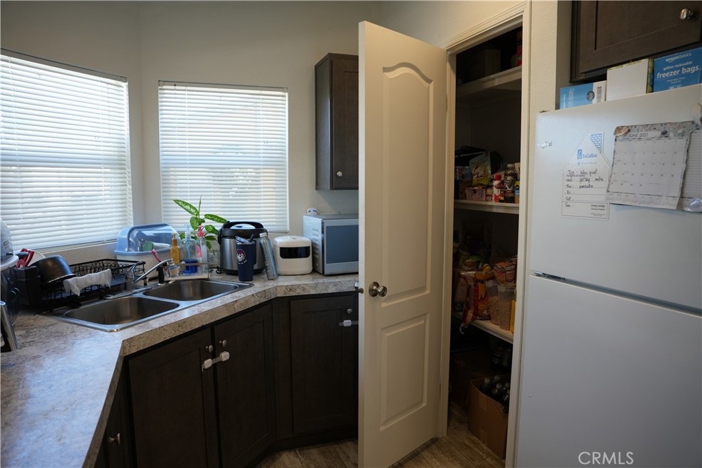 6545 Wilbur, Unit 39 Reseda, CA 91335 - Photo 6 of 27 a kitchen with a refrigerator and a sink