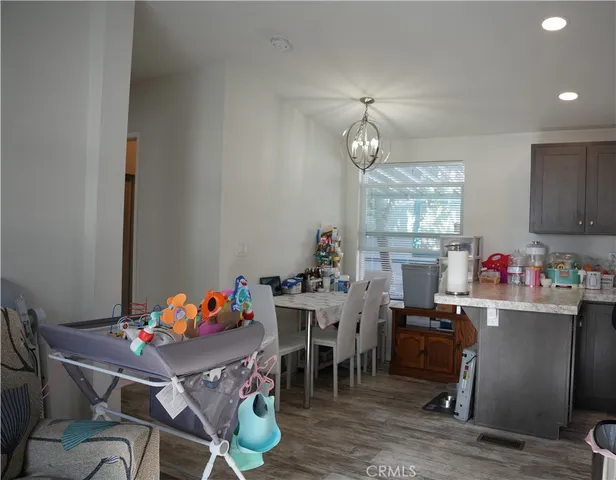 a view of a dining room with furniture and chandelier